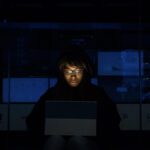 man writes code in the dark